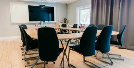 conference room with eight chairs around a table