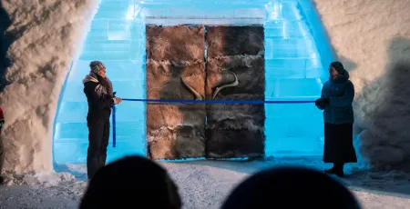 two people standing on each side of Icehotel entrance