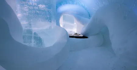 bed covered with reindeer hides surrounded by ice art