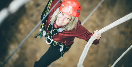 A women climbind in the challenge park