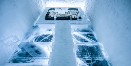 dock on water leading to the bed in art suite made of snow and ice